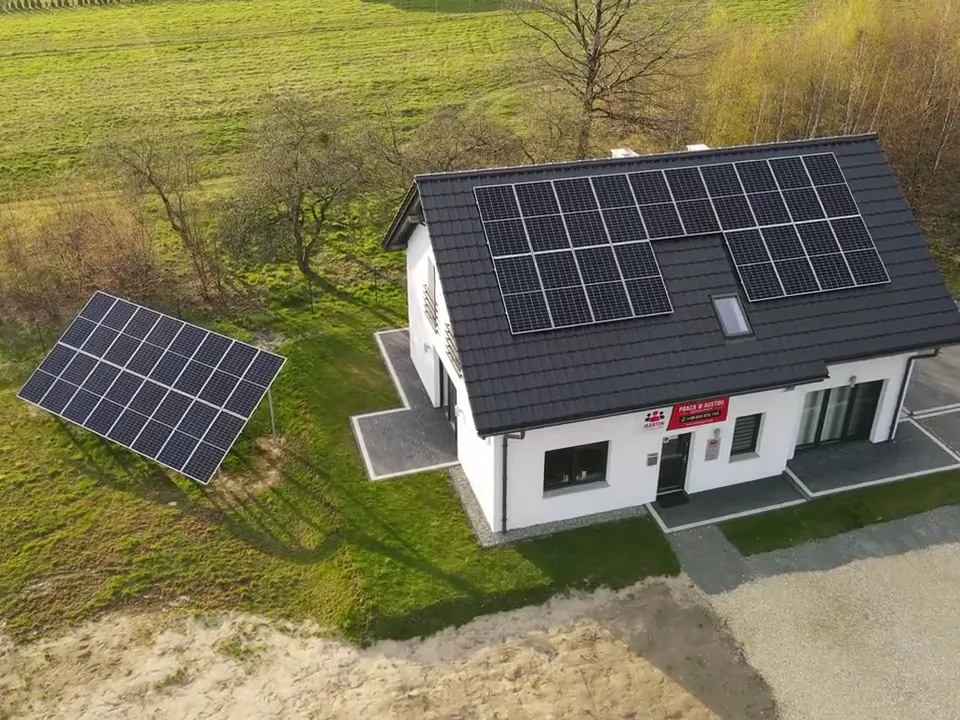 Instalacja fotowoltaiczna 14,96 kWp w Wodzisławiu Śląskim: panele na dachu domu i na konstrukcji w ogrodzie, widok z drona